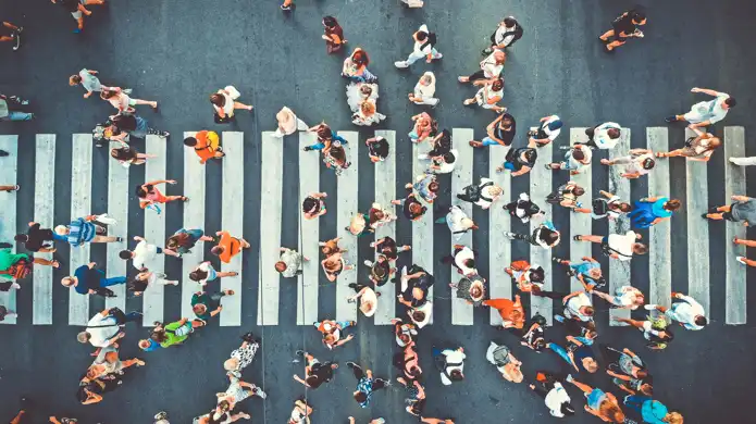 A group of people standing in the middle of a street.